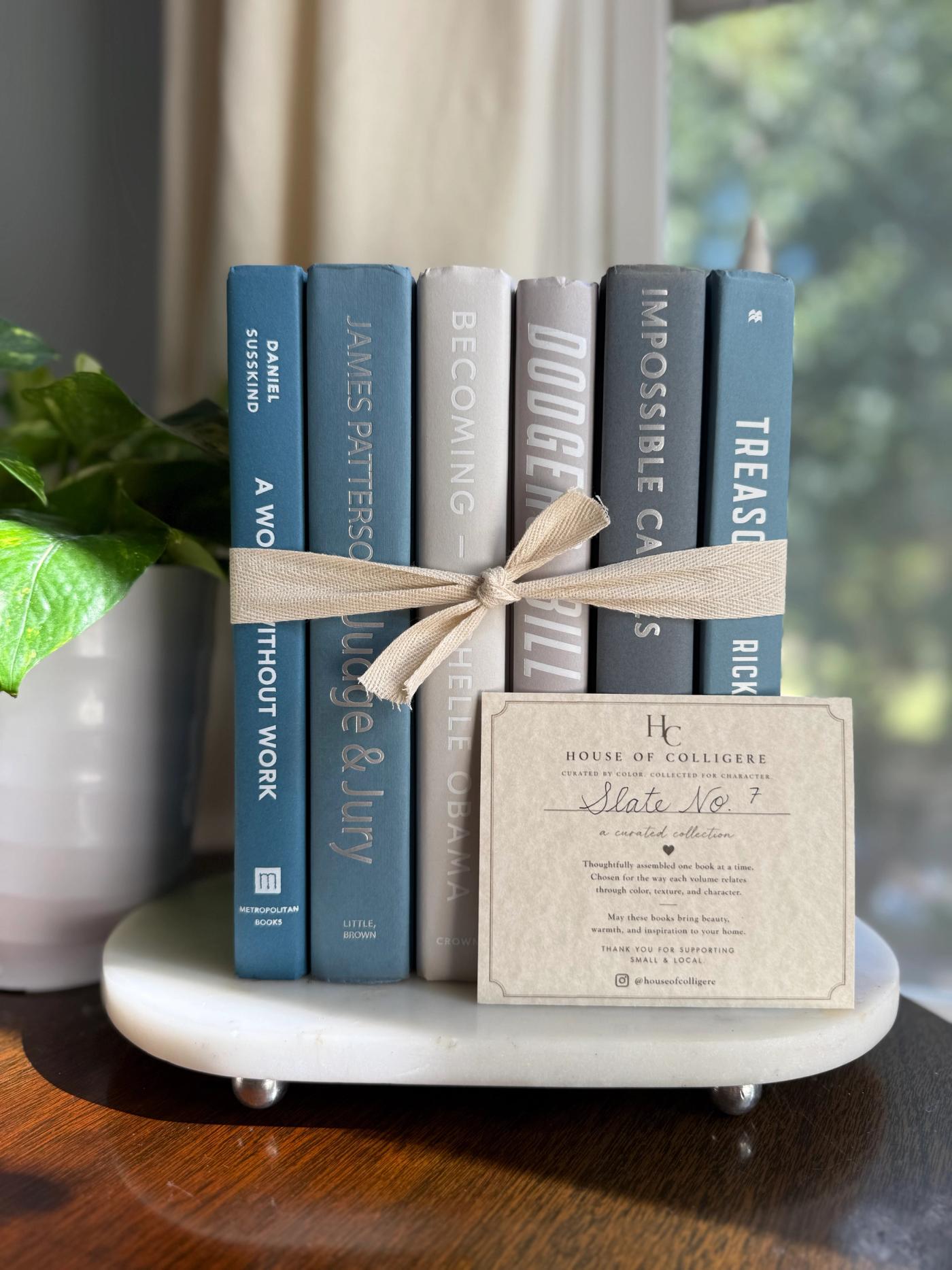 Curated collection of muted blue-gray, slate, charcoal, and softly weathered neutral books.