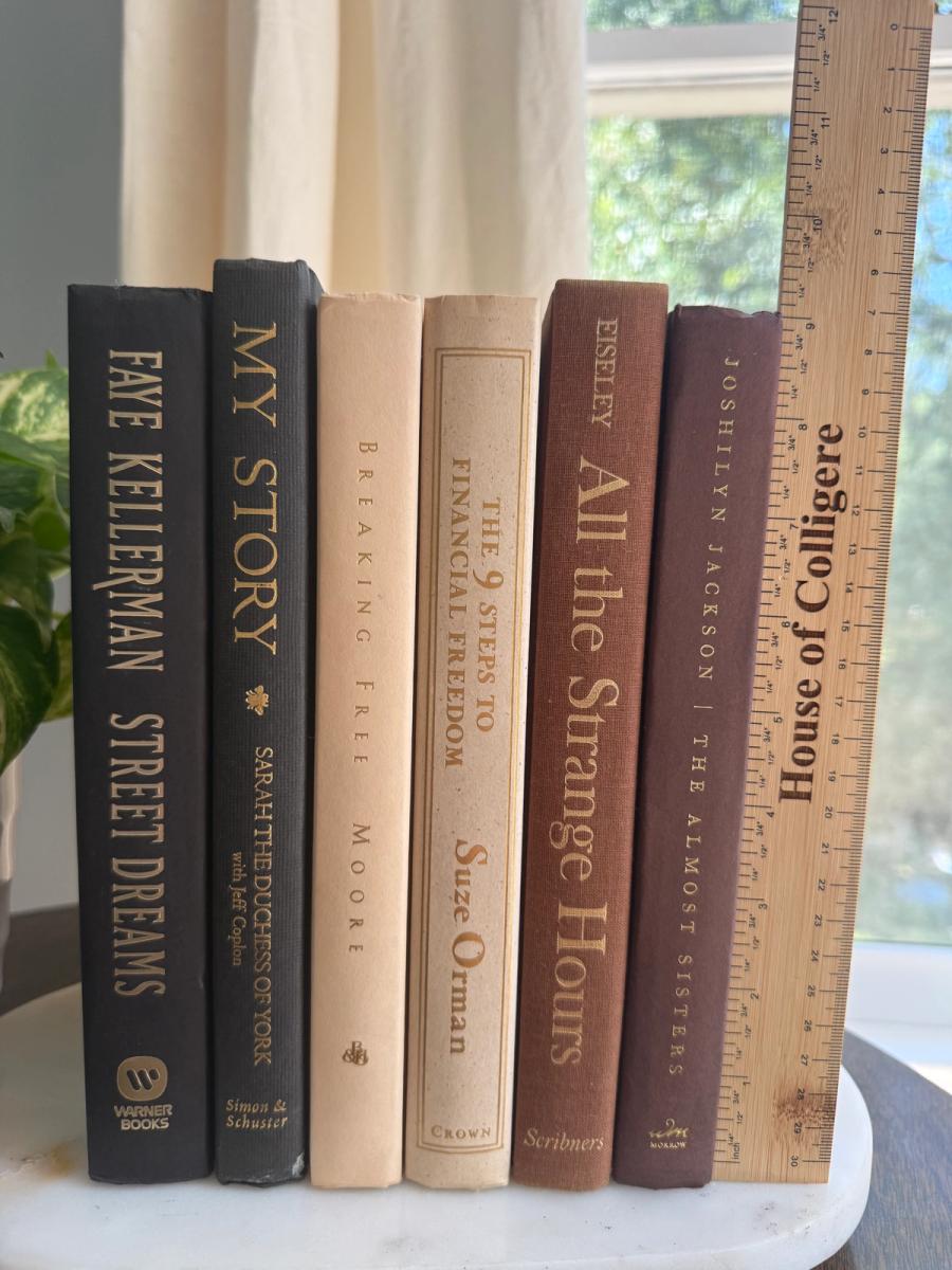 Curated collection of warm brown, olive, tan, and aged neutral books with a traditional library palette.