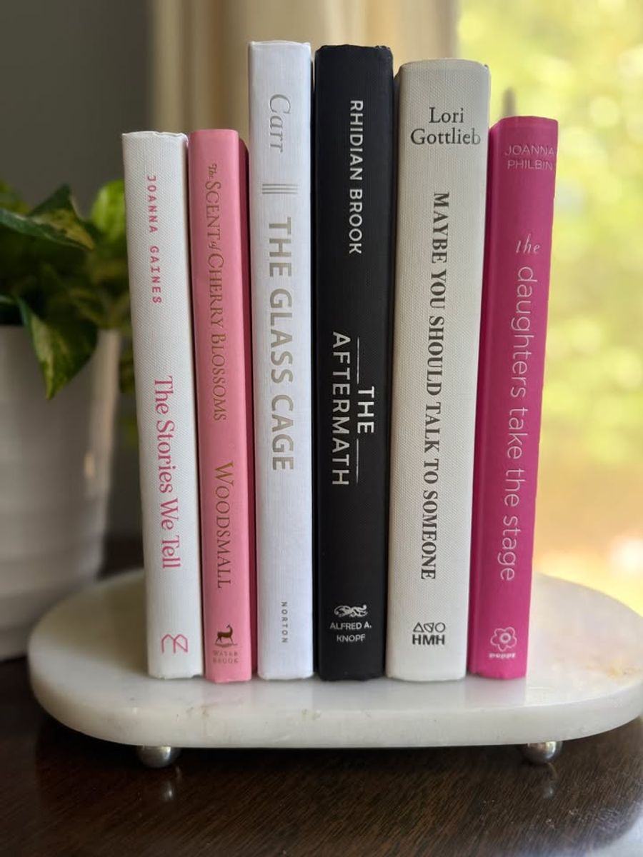 Modernist Edit No. 10 decorative book collection in white, blush pink, black, and raspberry tones, tied with neutral linen ribbon and styled on a marble table.