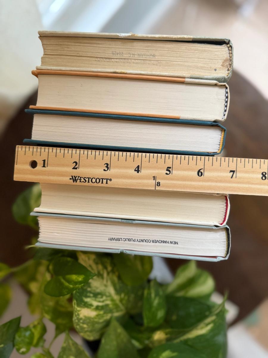 Curated collection of white, pale blue, sand, and soft coastal-neutral books with an airy, sun-faded look.