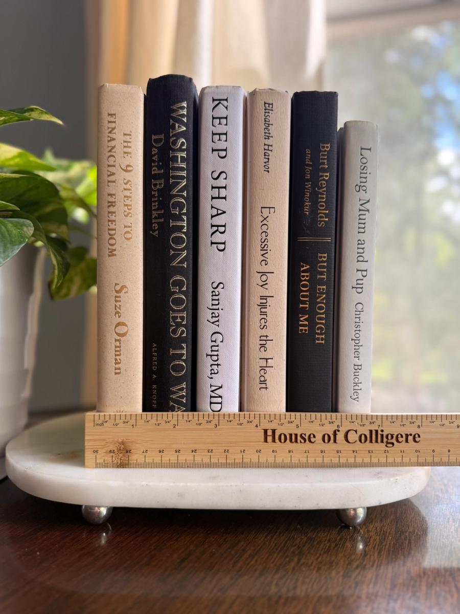 Curated collection of parchment, cream, warm beige, and black books with soft neutral contrast and classic detailing.
