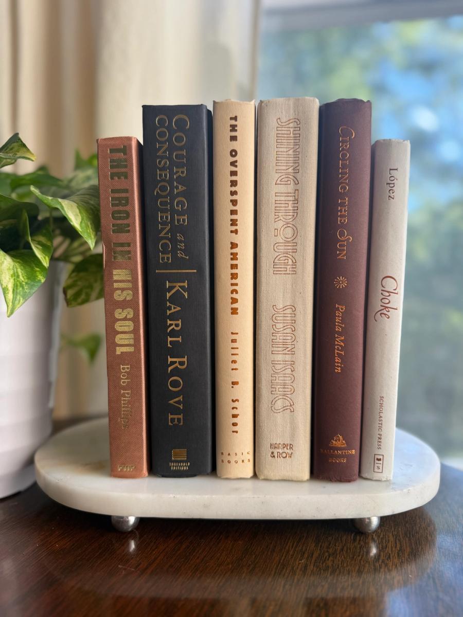 Curated collection of warm brown, olive, tan, and aged neutral books with a traditional library palette.
