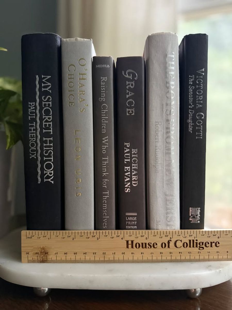 Curated collection of warm brown, olive, tan, and aged neutral books with a traditional library palette.