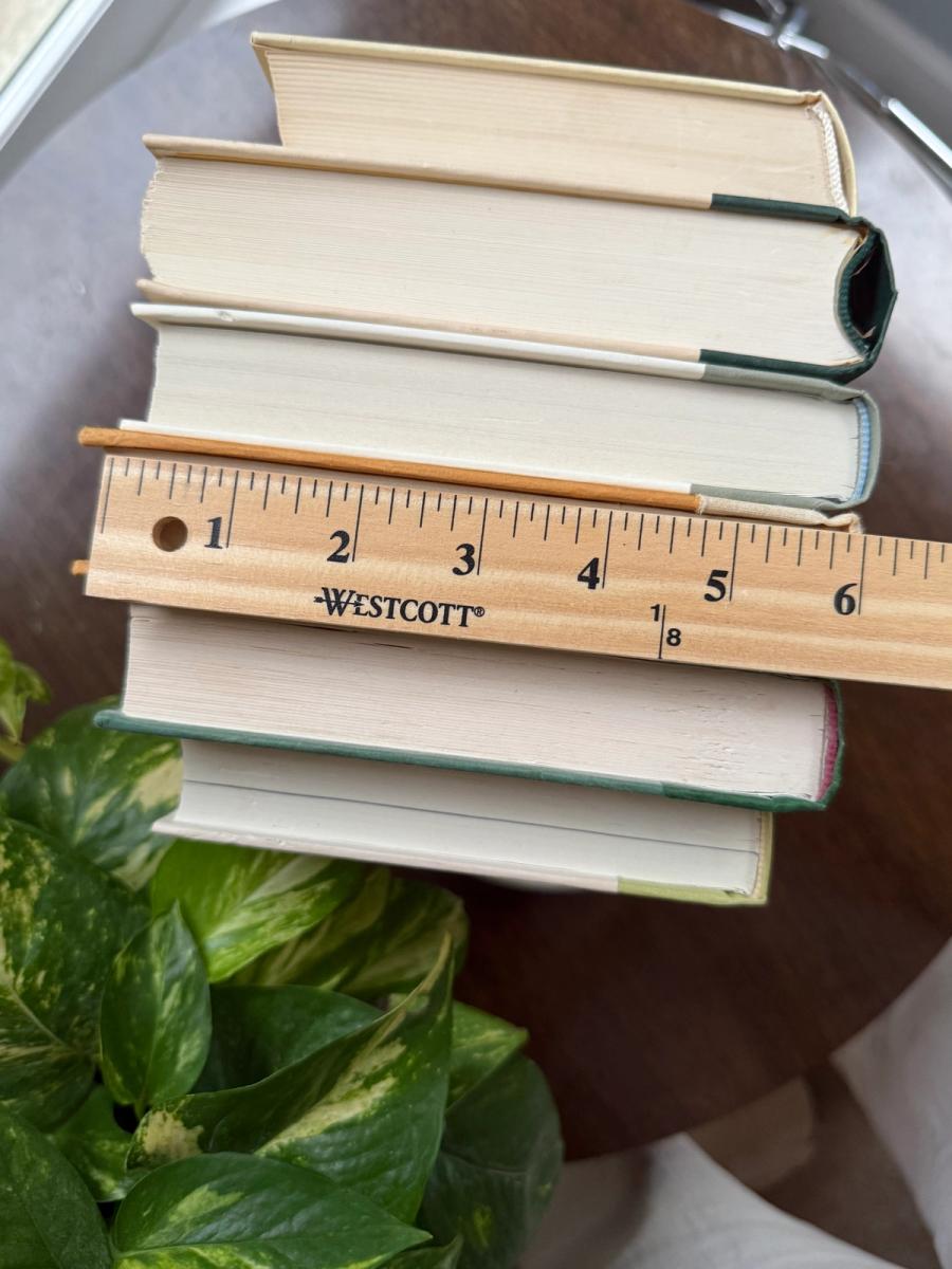 Curated collection of soft sage, olive, cream, and muted green books with botanical tones.