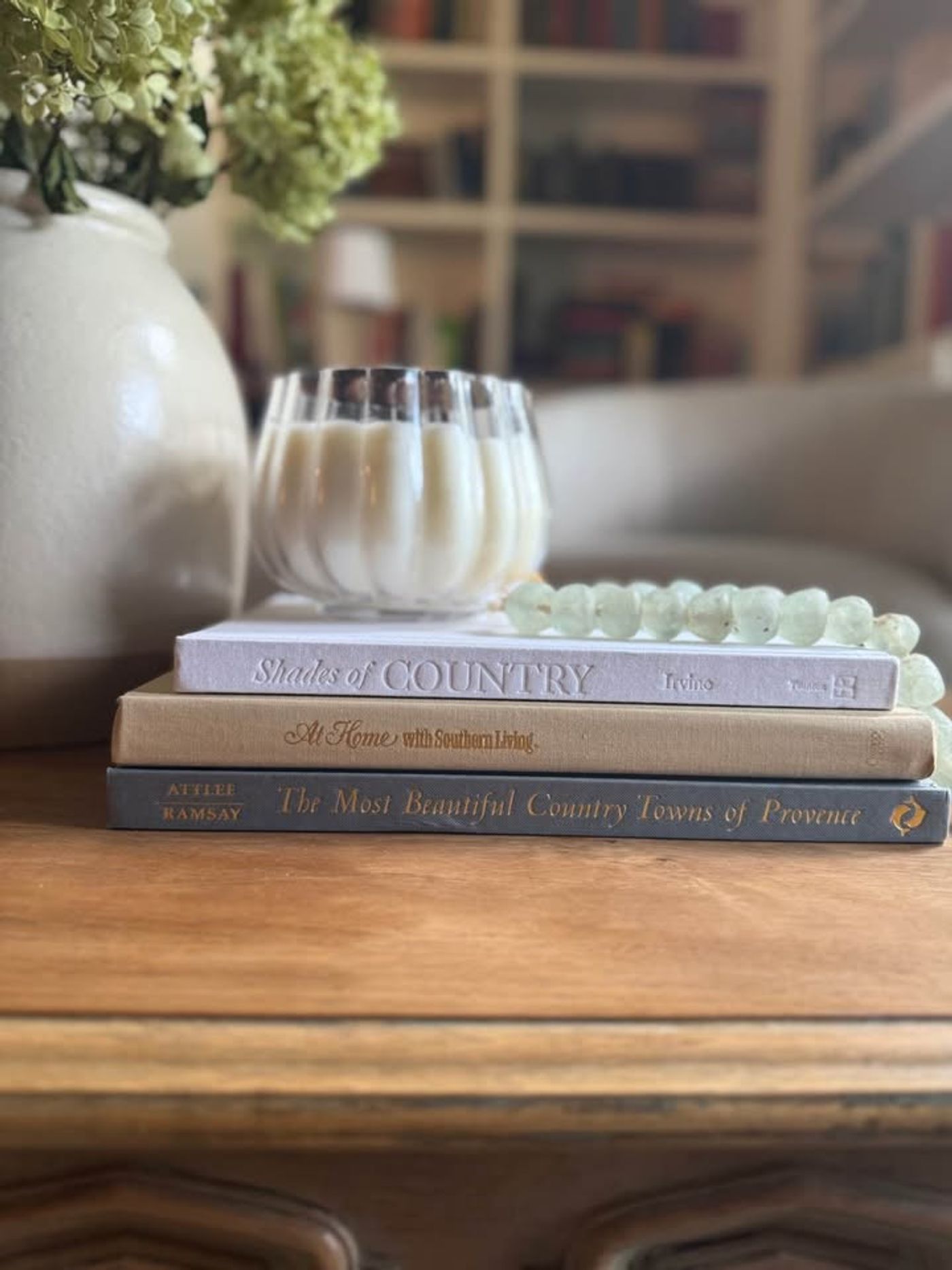 Cream, ivory, warm flax, beige, muted blue-gray, soft taupe undertones, linen-like cloth covers, matte woven texture, subtle gold and metallic lettering, understated traditional styling