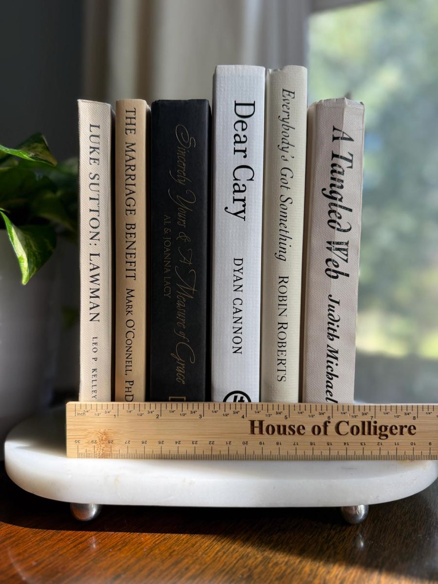 Curated collection of parchment, cream, warm beige, and black books with soft neutral contrast and classic detailing.