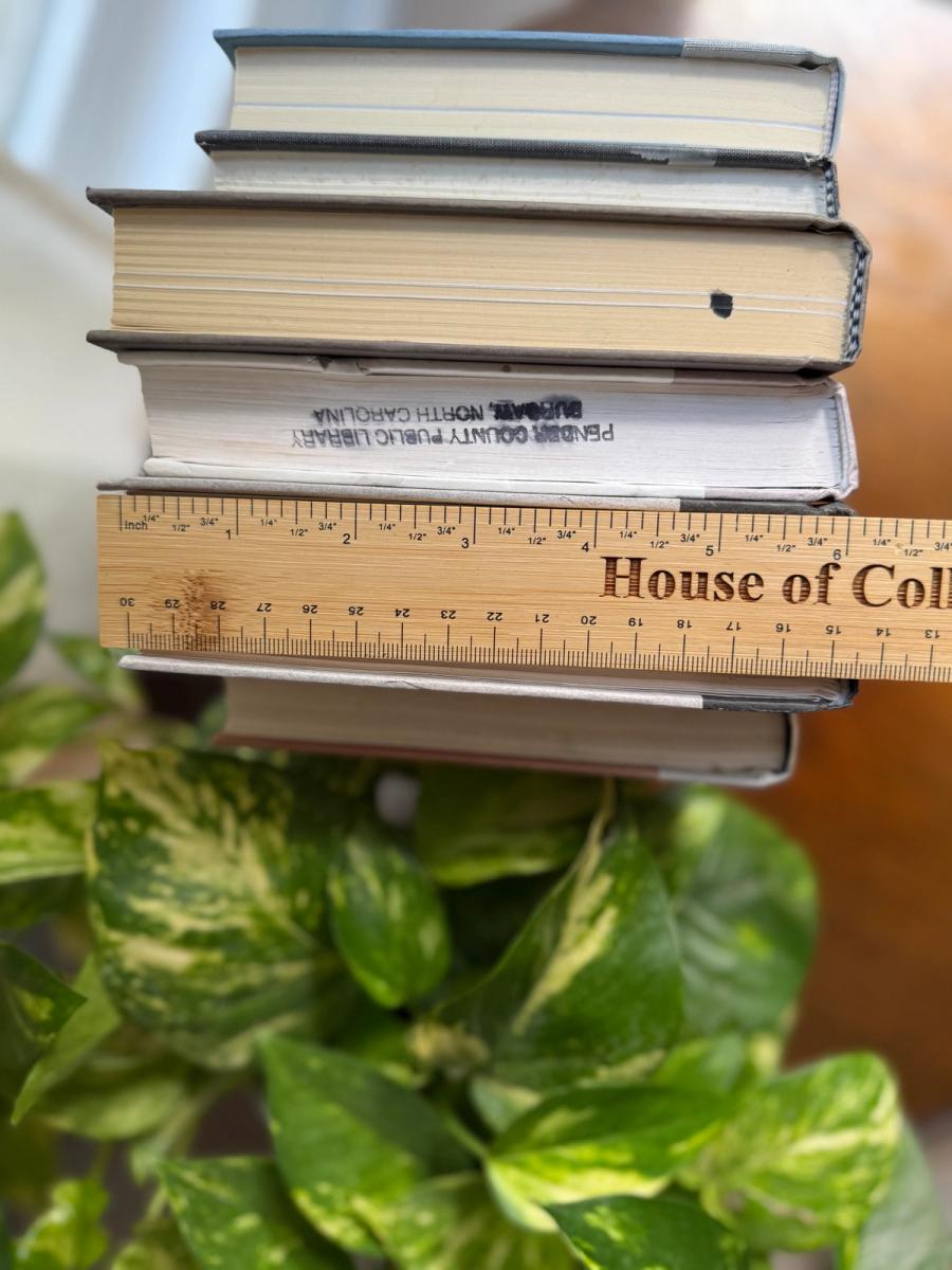 Curated collection of soft white, pale gray, warm greige, and stone-toned books with subtle tonal variation.