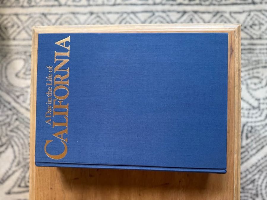 Blue, linen-like cloth covers, matte woven texture, subtle gold and metallic lettering, understated traditional styling