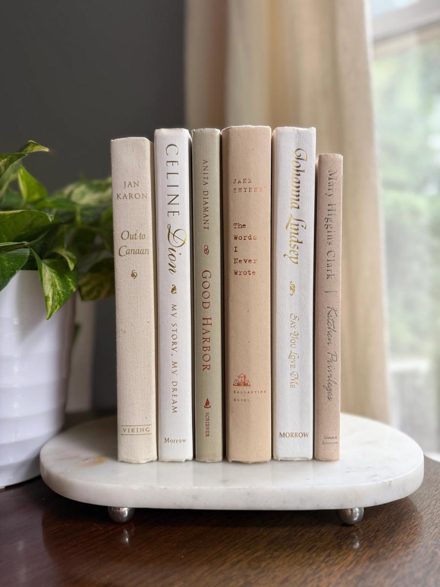 Curated collection of crisp white, ivory, and warm cream books with soft neutral tones.