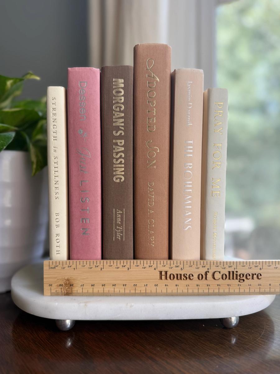 Curated collection of blush, dusty rose, warm taupe, and softly muted neutral books.