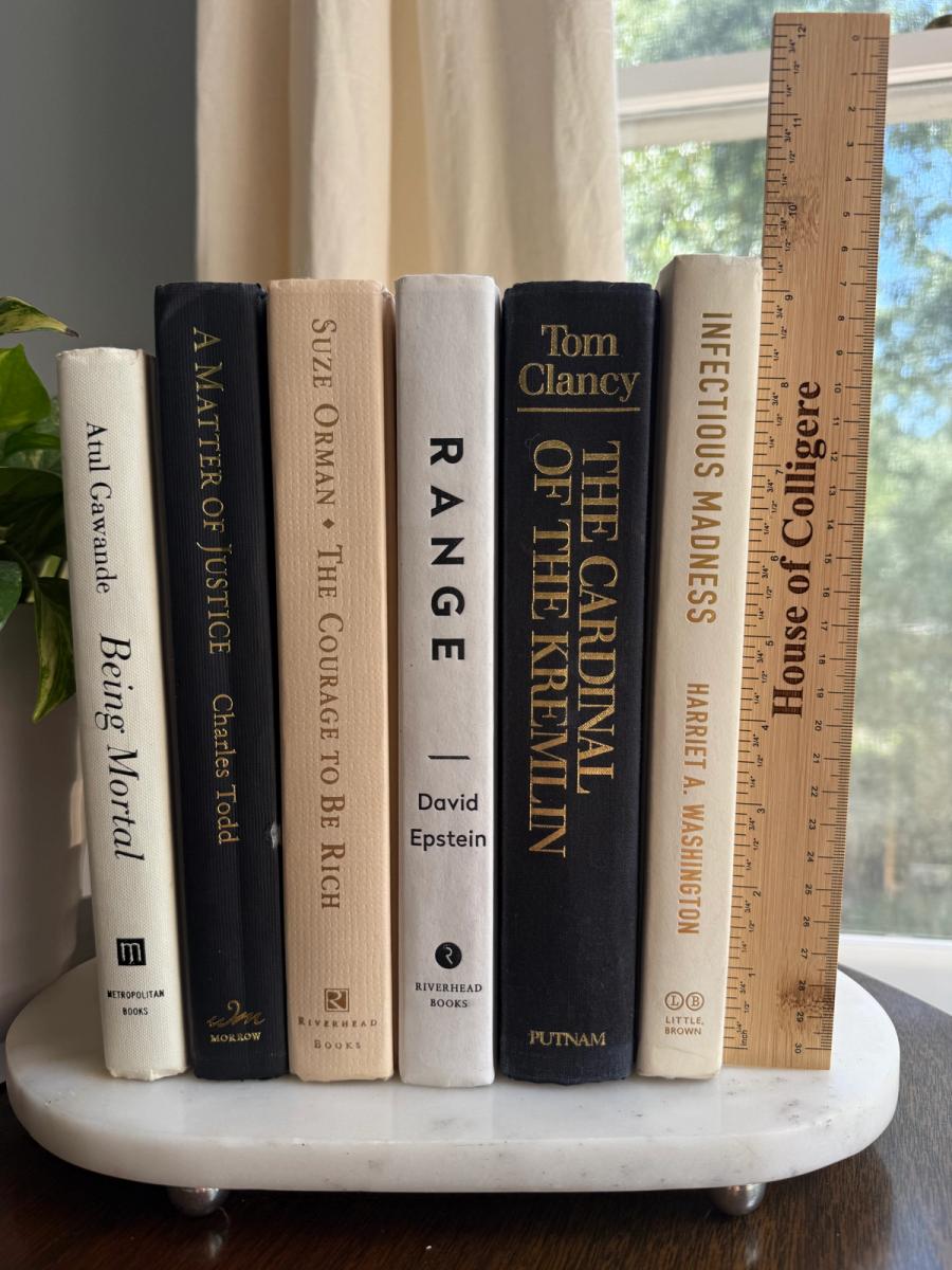 Curated collection of parchment, cream, warm beige, and black books with soft neutral contrast and classic detailing.