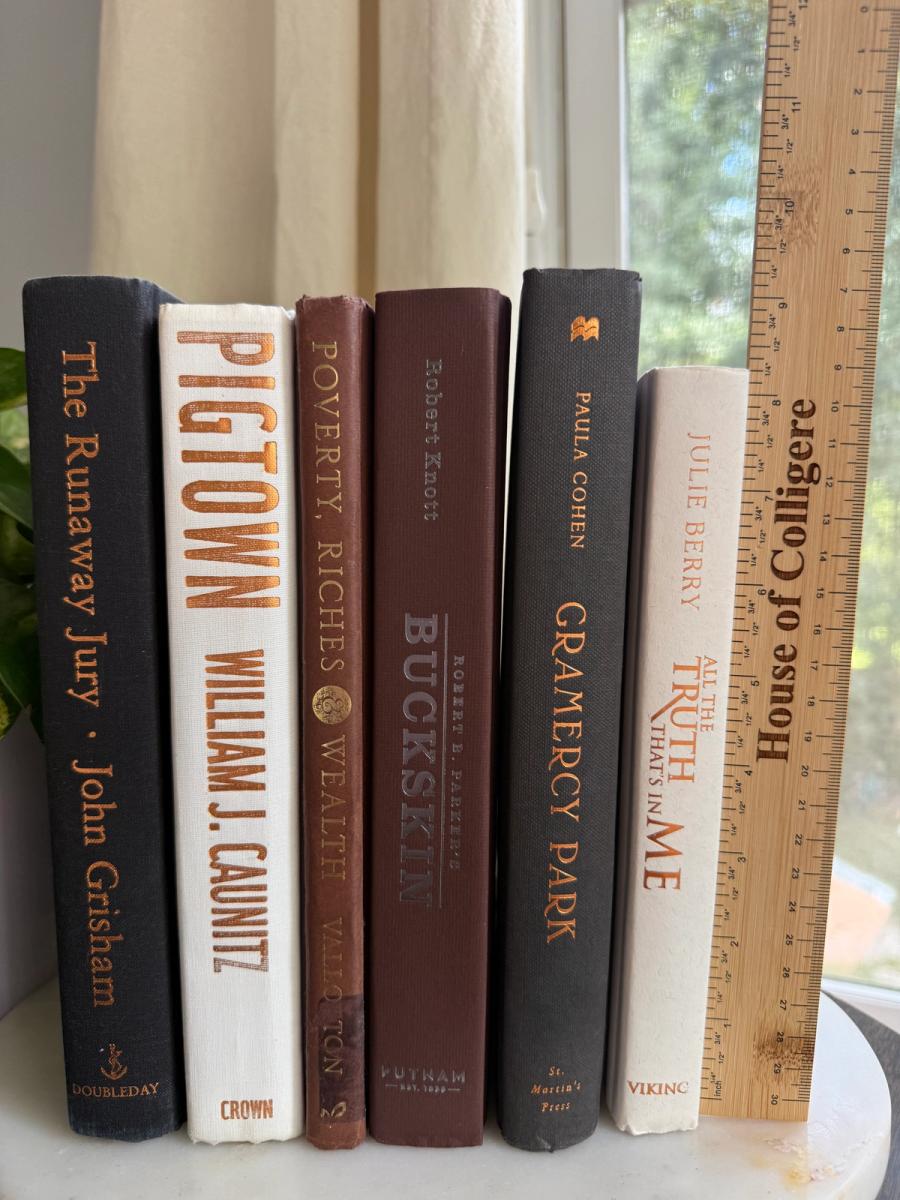 Curated collection of warm brown, olive, tan, and aged neutral books with a traditional library palette.