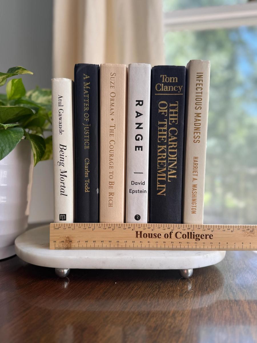 Curated collection of parchment, cream, warm beige, and black books with soft neutral contrast and classic detailing.