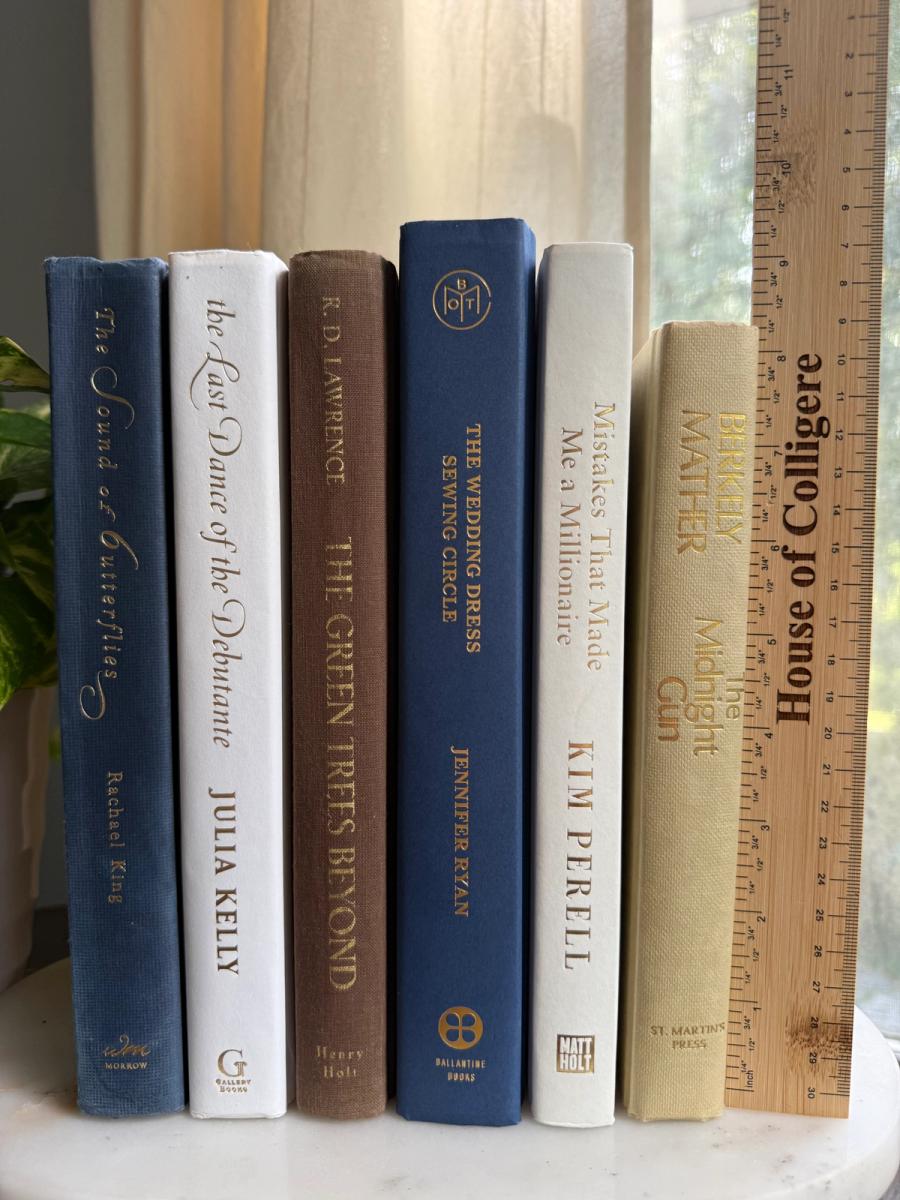 Curated collection of weathered blue, oyster, sand, linen, and driftwood-toned books with soft coastal character.