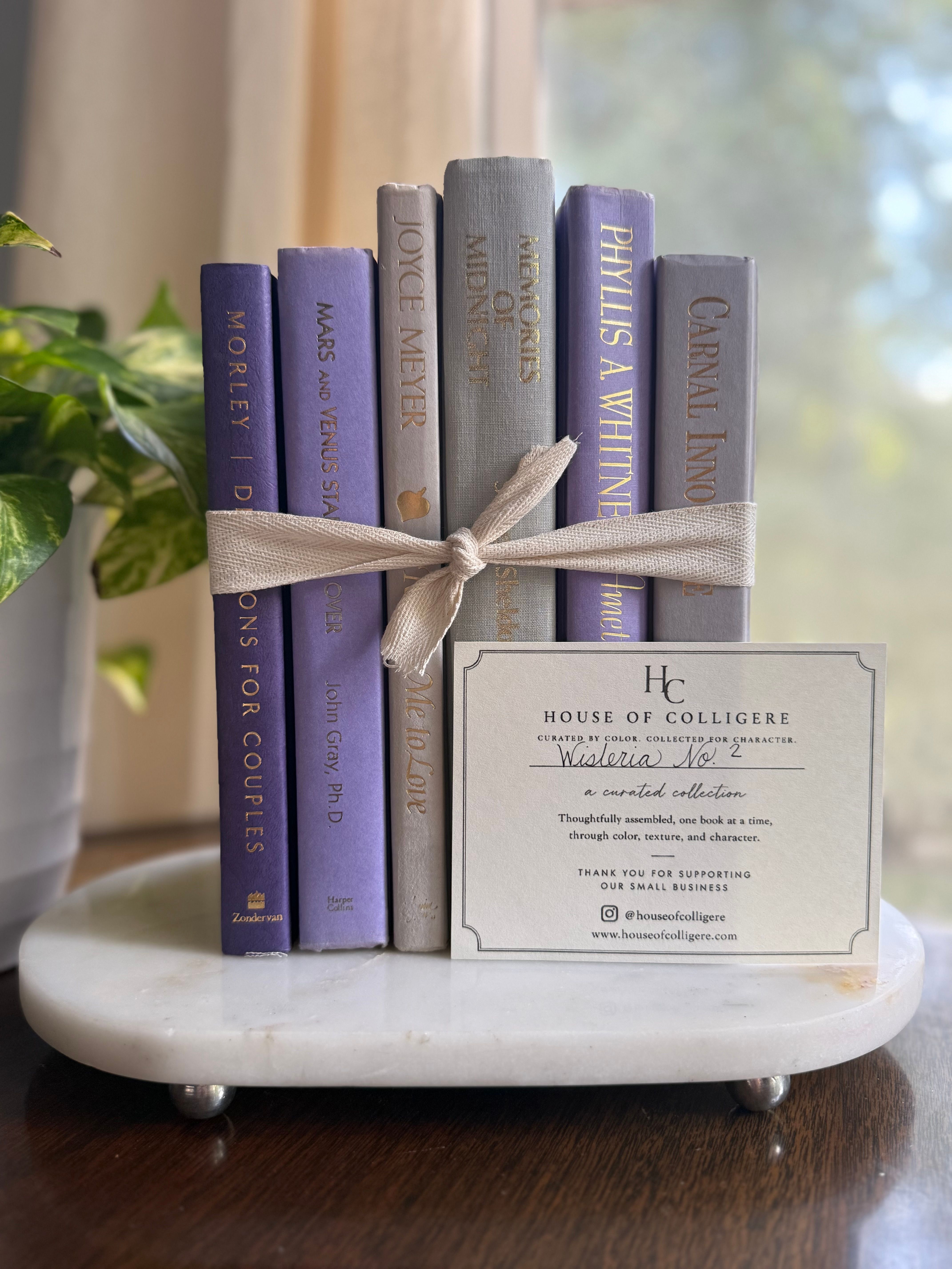 Curated collection of lavender, lilac, orchid, and violet books with soft tonal variation and floral-inspired color.