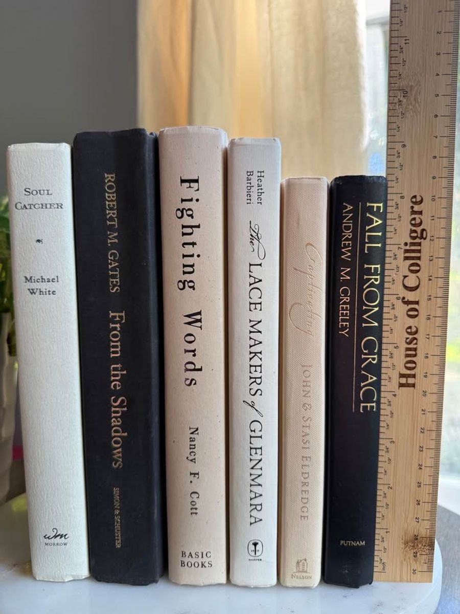 Curated collection of parchment, cream, warm beige, and black books with soft neutral contrast and classic detailing.