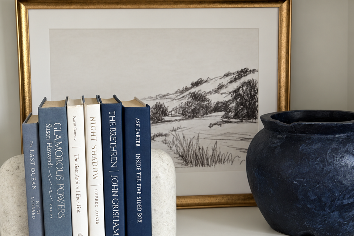 Curated collection of layered blue books ranging from pale coastal blue to deeper ocean tones.
