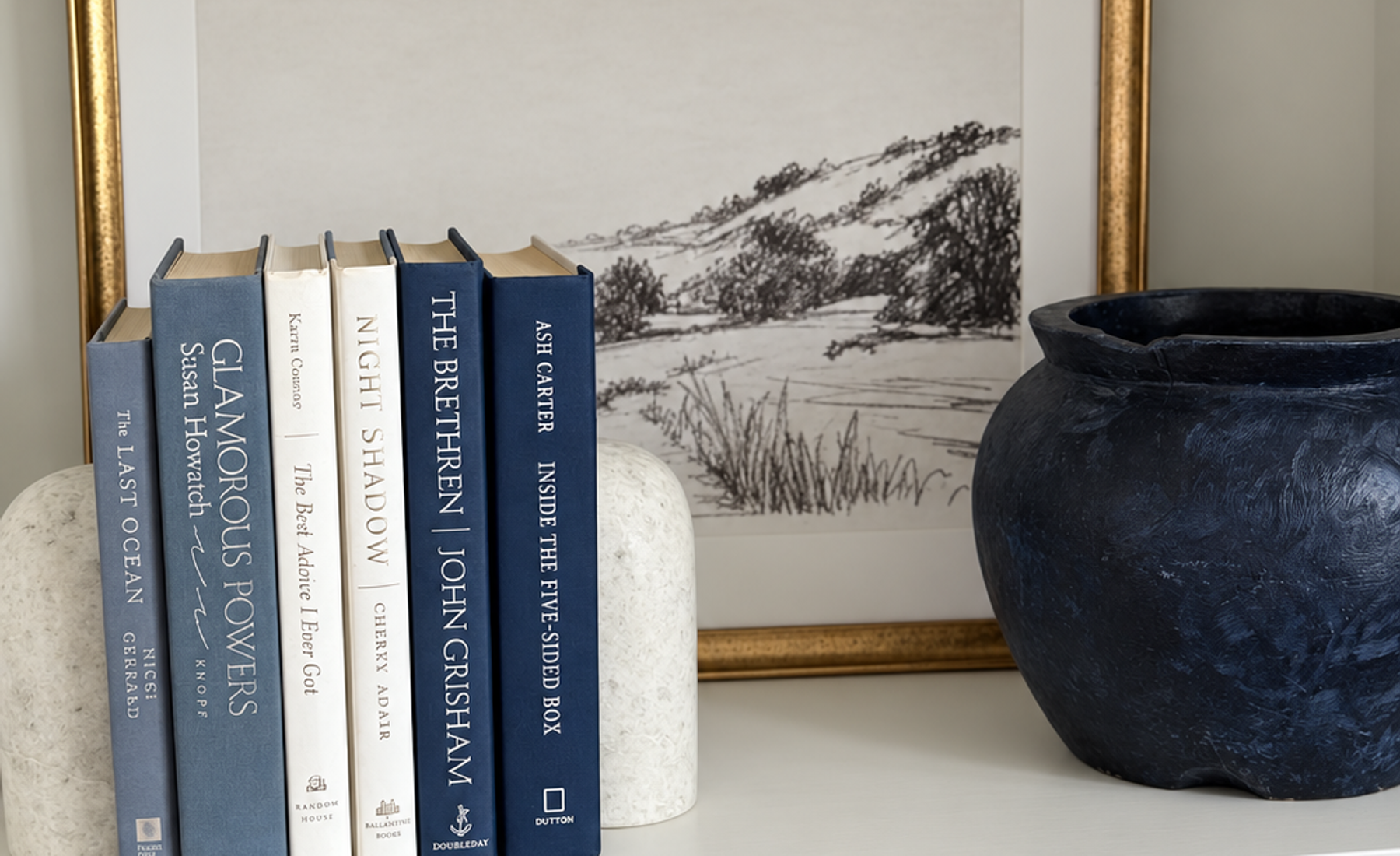 Curated collection of layered blue books ranging from pale coastal blue to deeper ocean tones.