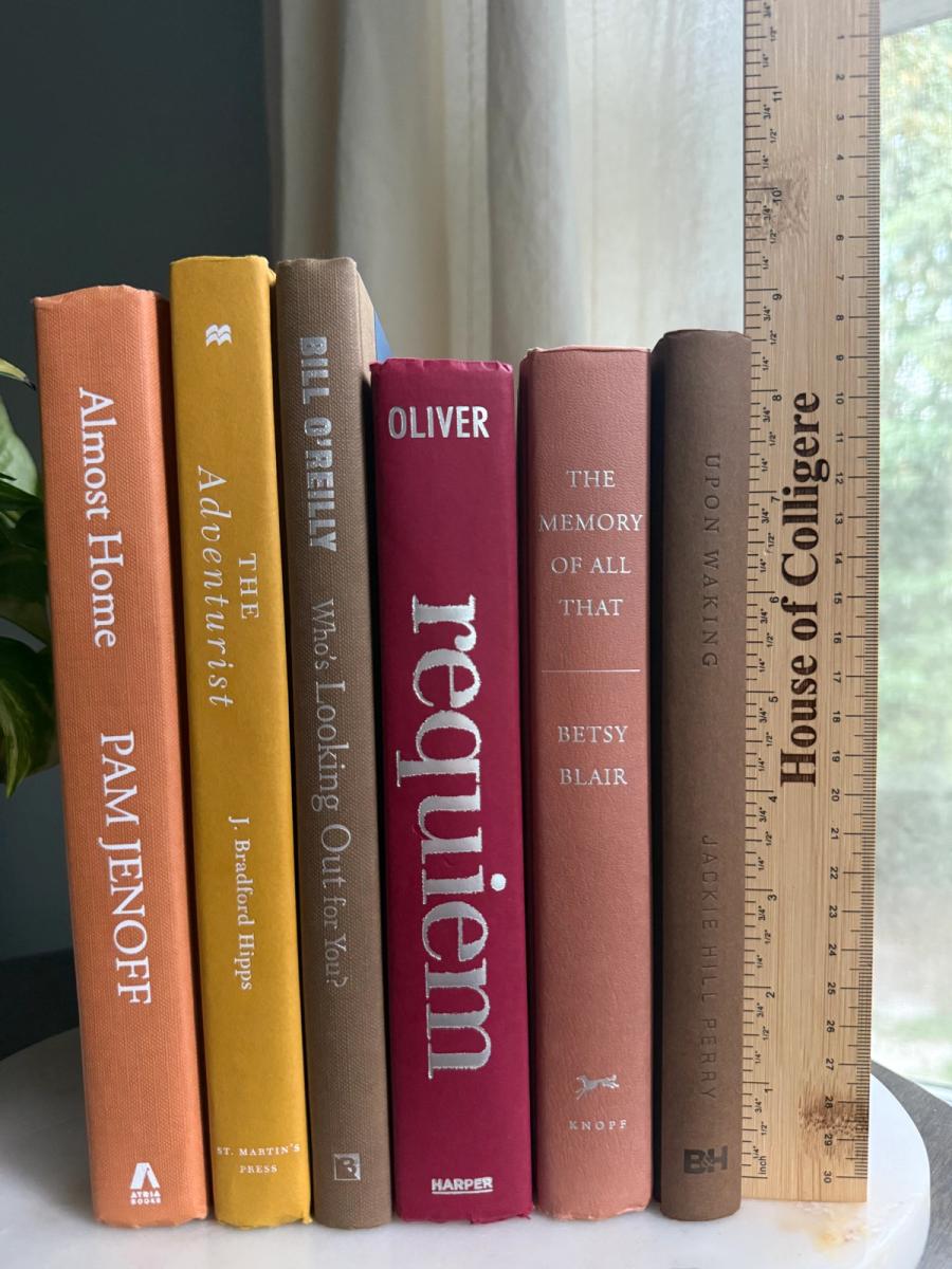 Curated collection of dusty rose, plum, warm brown, taupe, and muted berry-toned books with soft vintage character.