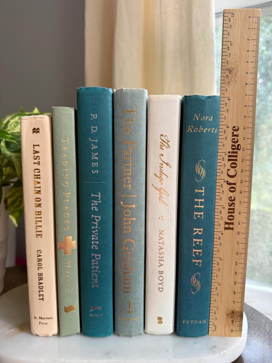 Curated collection of white, pale blue, sand, and soft coastal-neutral books with an airy, sun-faded look.