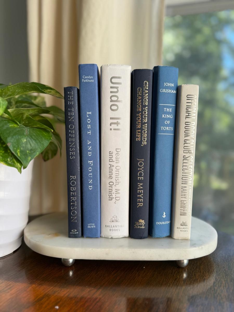 Curated collection of layered blue books ranging from pale coastal blue to deeper ocean tones.
