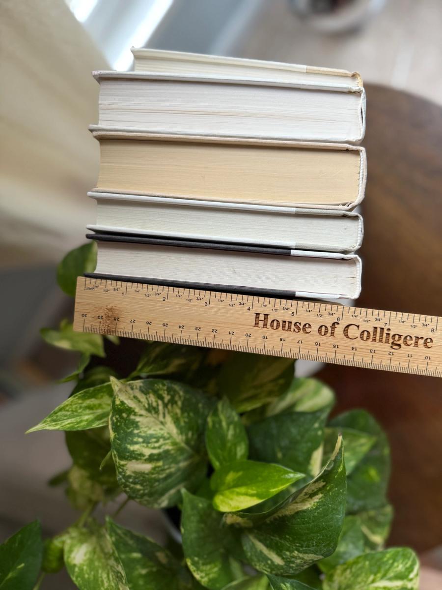 Curated collection of crisp white, ivory, and warm cream books with soft neutral tones.