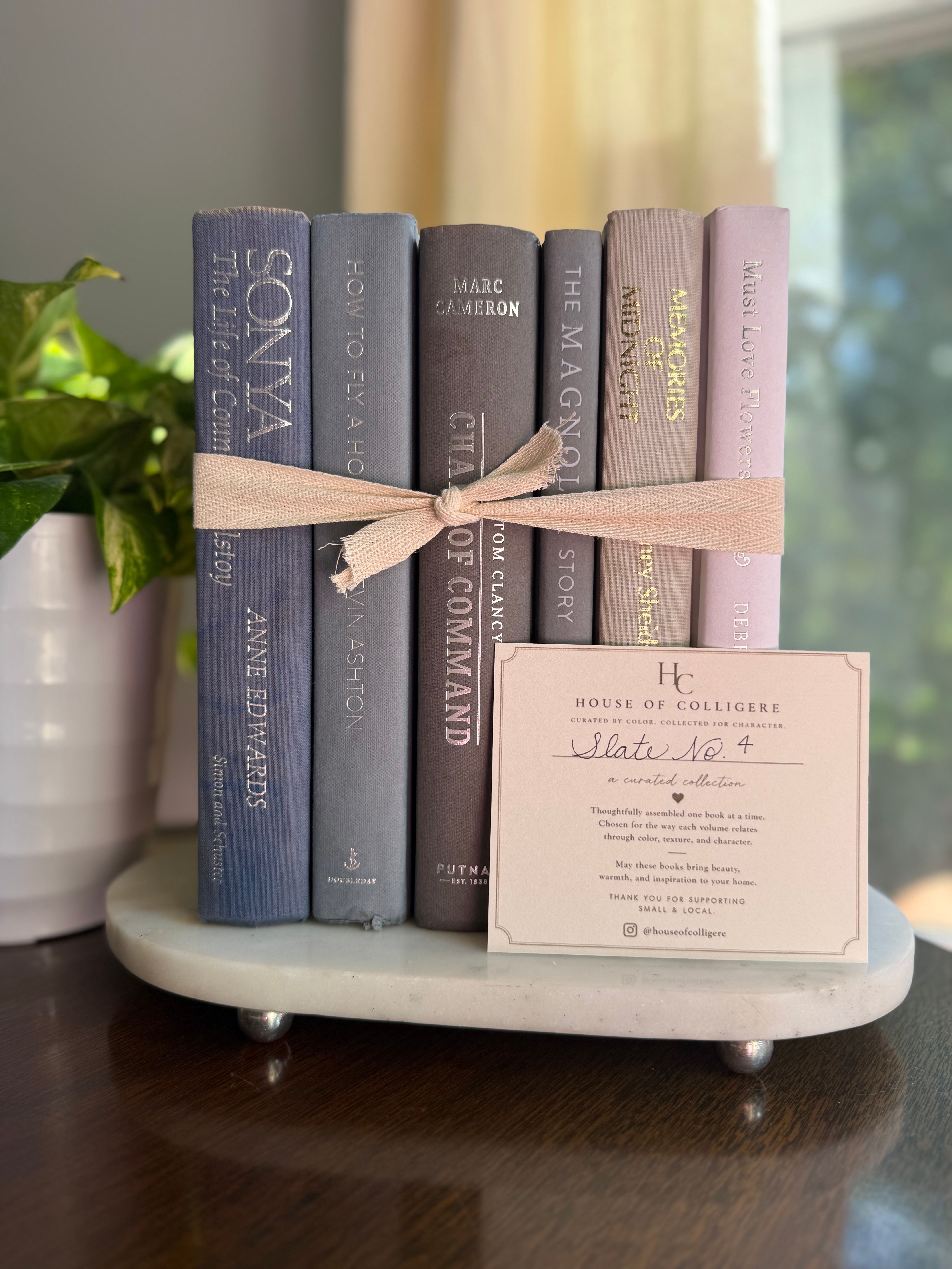 Curated collection of muted blue-gray, slate, charcoal, and softly weathered neutral books.