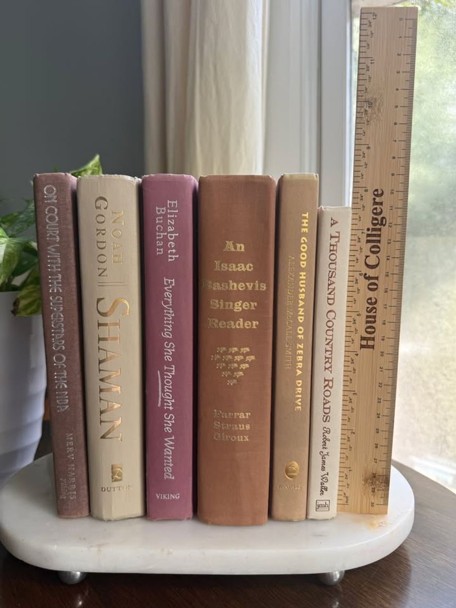 Curated collection of blush, dusty rose, warm taupe, and softly muted neutral books.