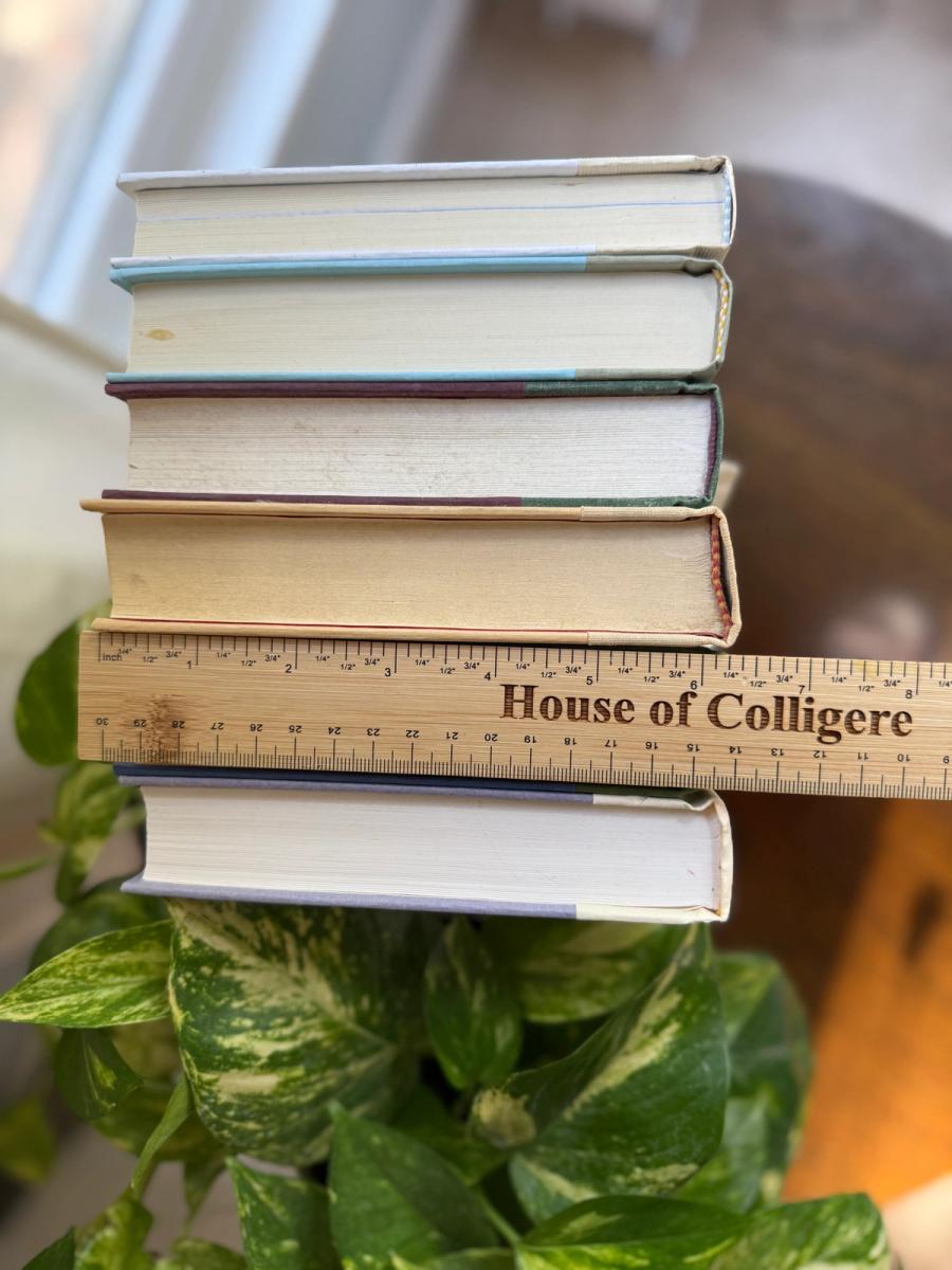 Curated collection of soft sage, olive, cream, and muted green books with botanical tones.