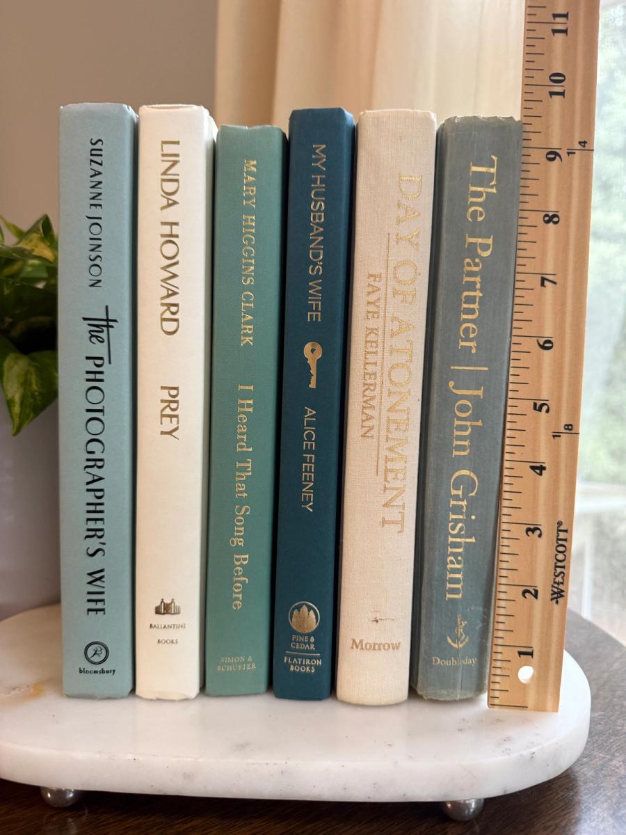 Curated collection of white, pale blue, sand, and soft coastal-neutral books with an airy, sun-faded look.