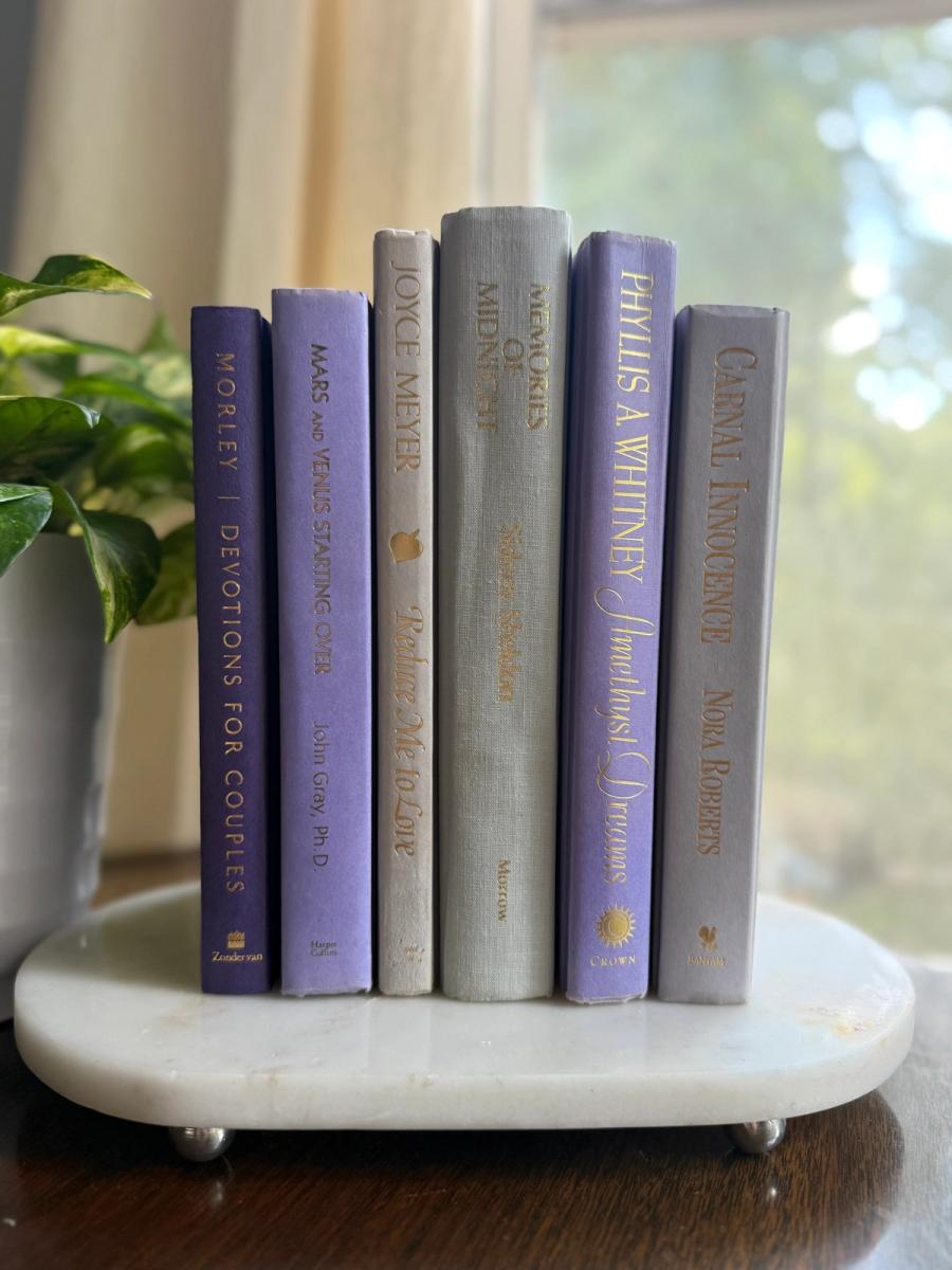 Curated collection of lavender, lilac, orchid, and violet books with soft tonal variation and floral-inspired color.