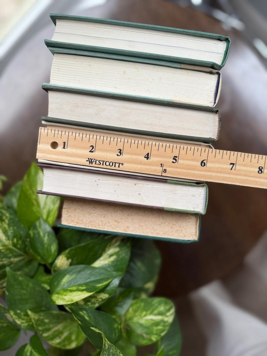 Curated collection of soft sage, olive, cream, and muted green books with botanical tones.