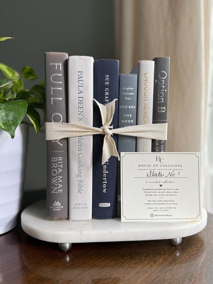 Curated collection of muted blue-gray, slate, charcoal, and softly weathered neutral books.