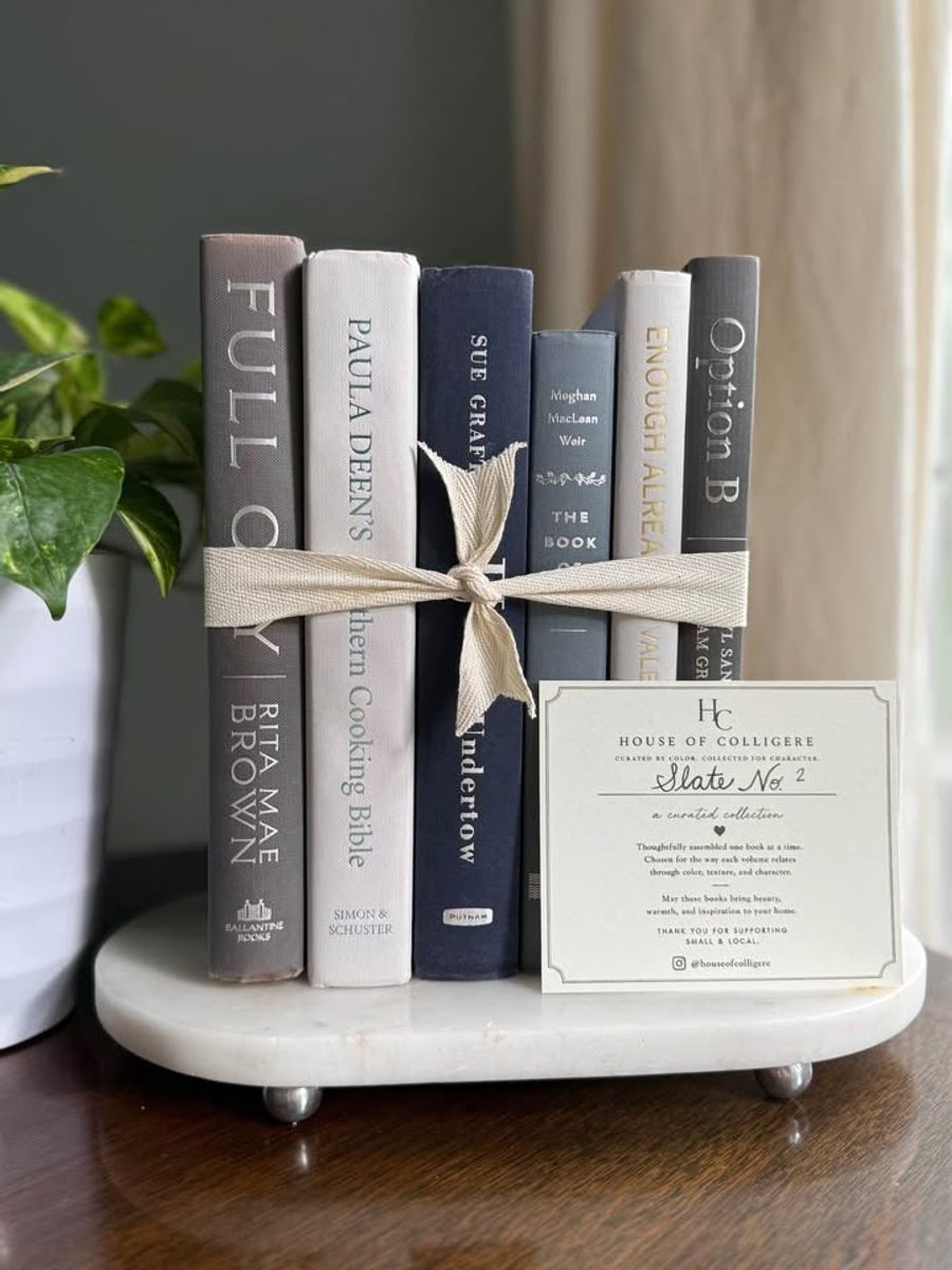 Curated collection of muted blue-gray, slate, charcoal, and softly weathered neutral books.