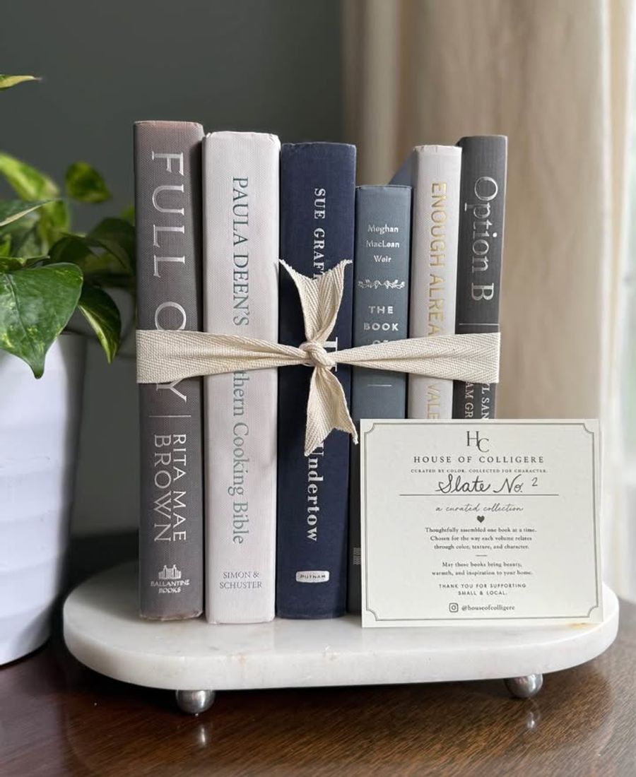 Curated collection of muted blue-gray, slate, charcoal, and softly weathered neutral books.
