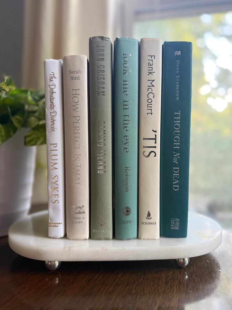 Curated collection of white, pale blue, sand, and soft coastal-neutral books with an airy, sun-faded look.