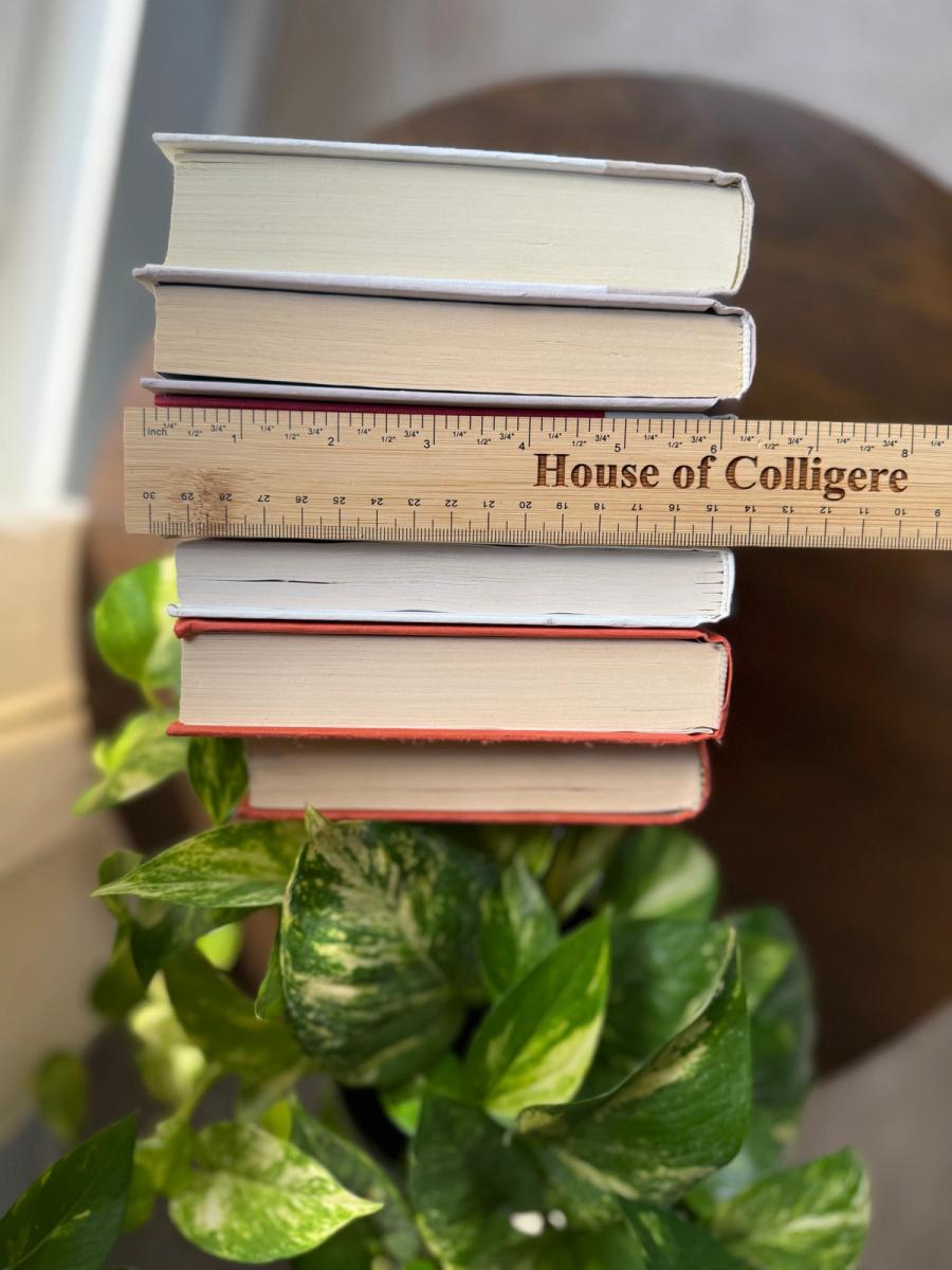 Six curated hardcover books in coral, ivory, soft gray, and muted lavender tones, tied with natural linen ribbon and displayed with a House of Colligere Modernist Edit No. 6 card