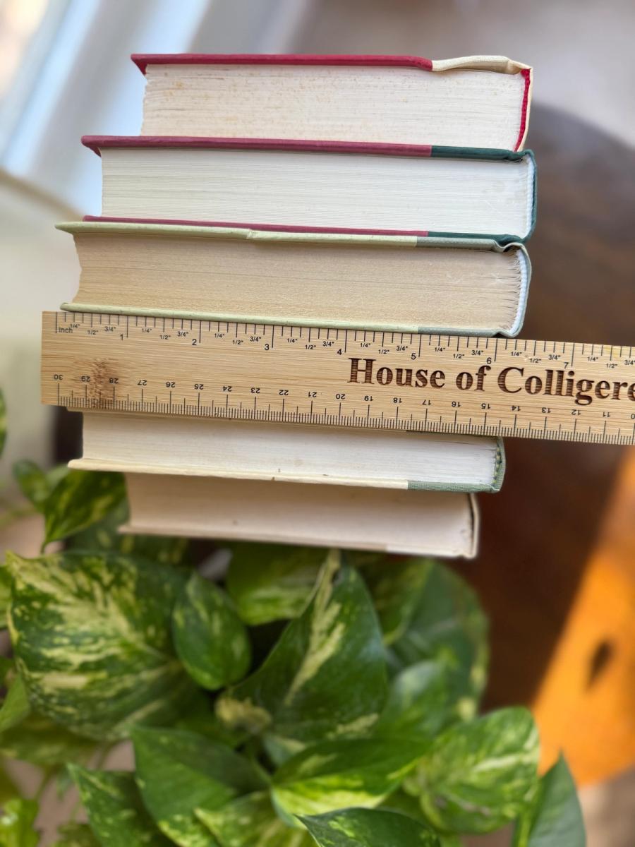 Curated collection of soft sage, olive, cream, and muted green books with botanical tones.