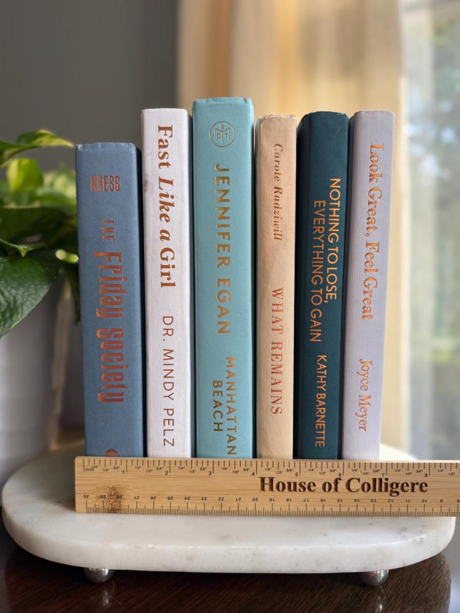 Curated collection of white, pale blue, sand, and soft coastal-neutral books with an airy, sun-faded look.