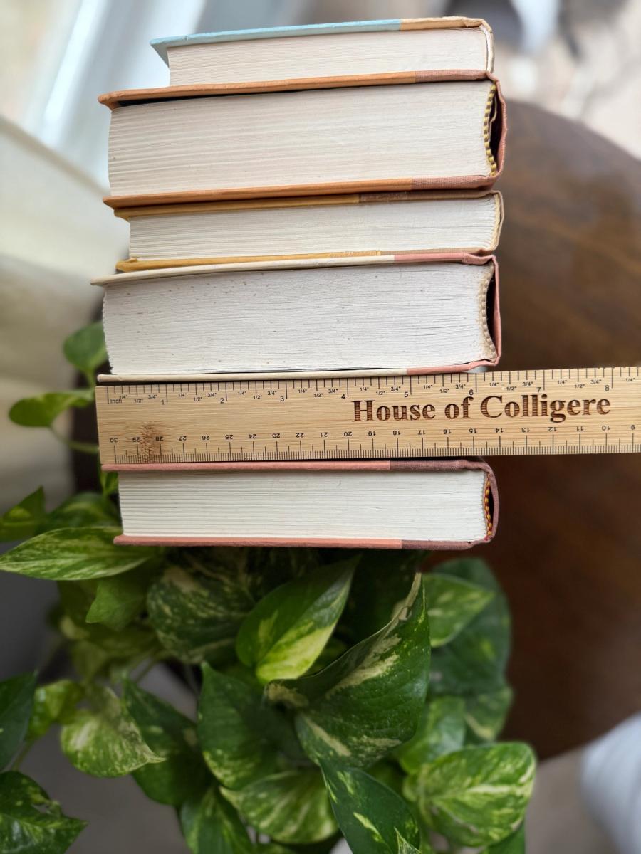 Curated collection of dusty rose, plum, warm brown, taupe, and muted berry-toned books with soft vintage character.
