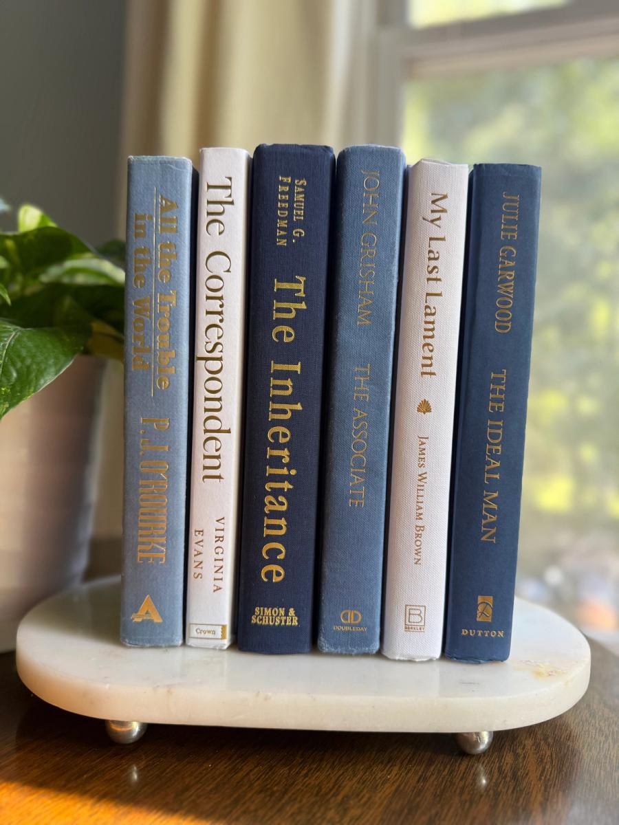 Curated collection of layered blue books ranging from pale coastal blue to deeper ocean tones.