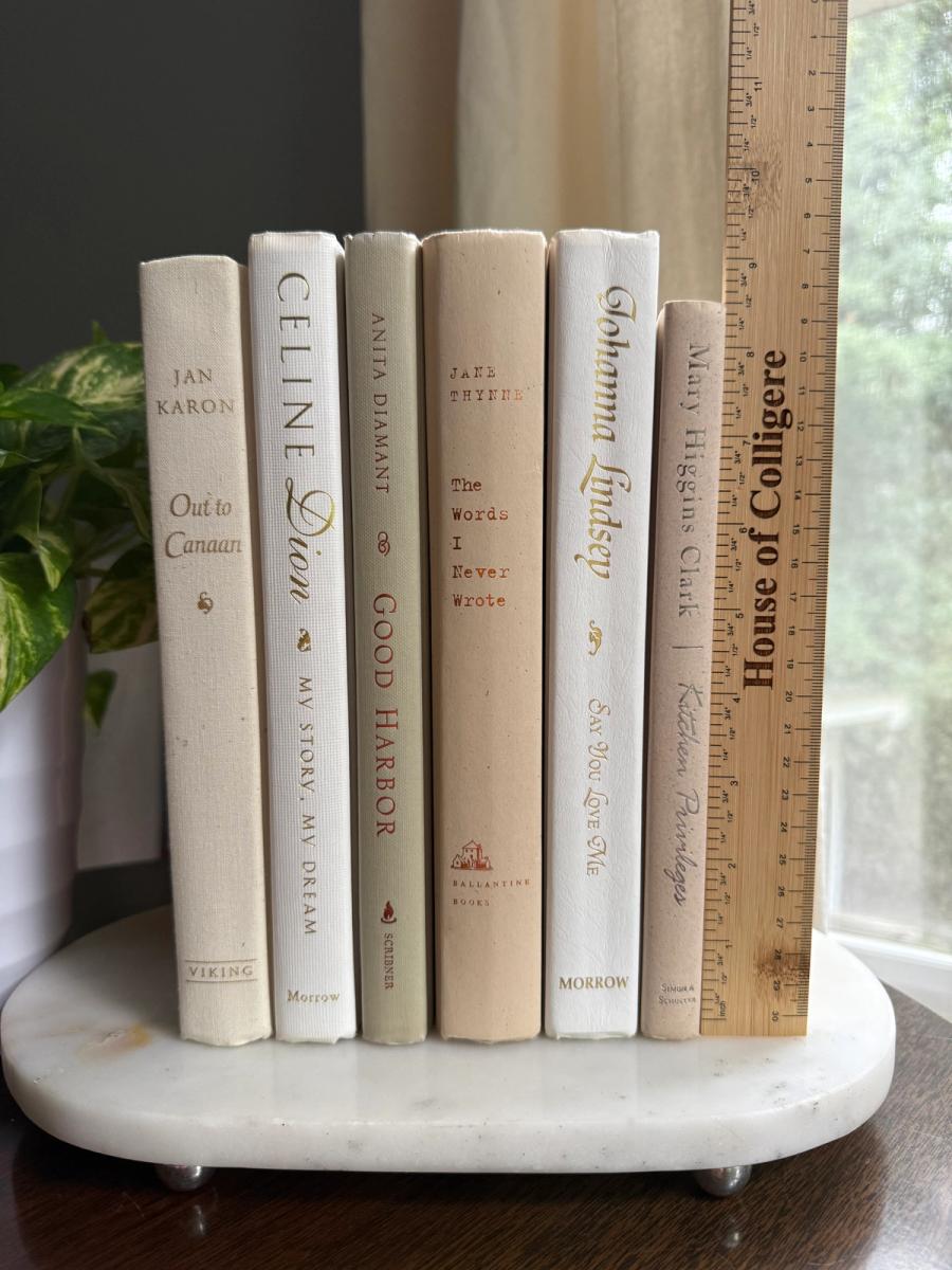 Curated collection of crisp white, ivory, and warm cream books with soft neutral tones.