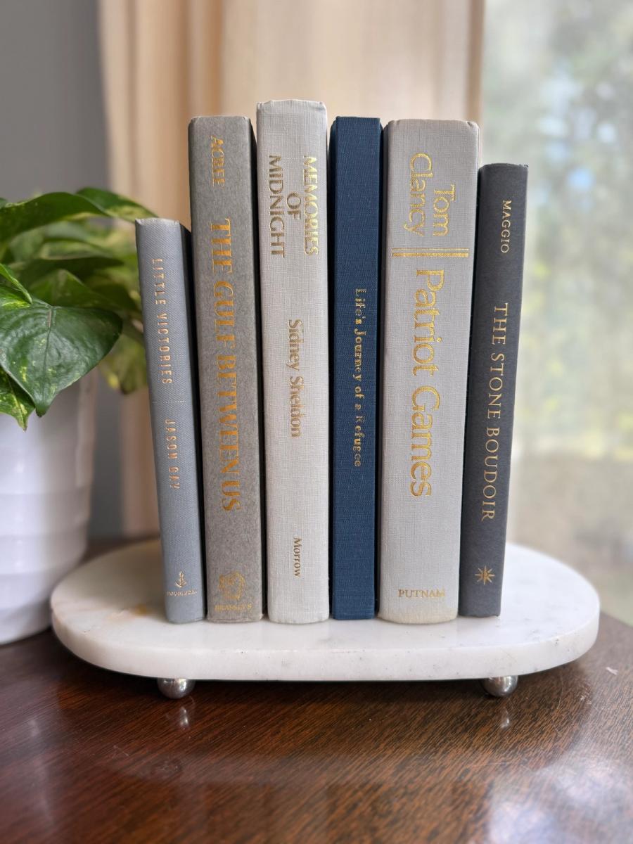 Curated collection of muted blue-gray, slate, charcoal, and softly weathered neutral books.