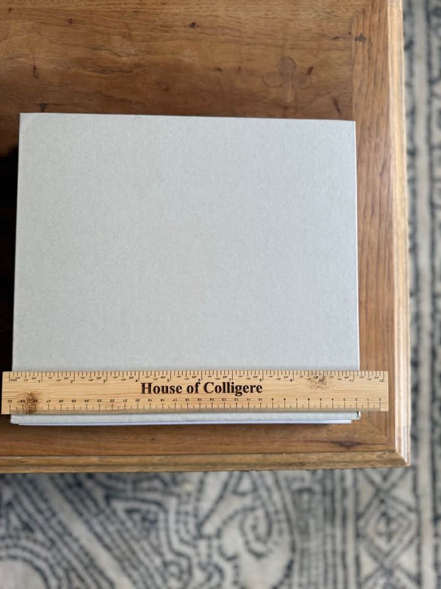 Coffee Table Design, White, beige, almond, linen-like cloth covers, matte woven texture, subtle gold and metallic lettering, understated traditional styling