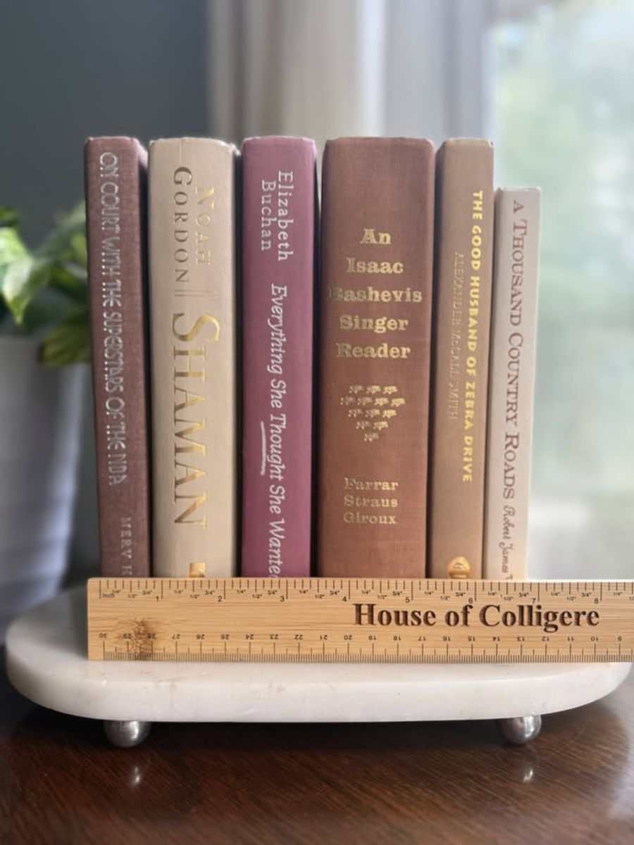Curated collection of blush, dusty rose, warm taupe, and softly muted neutral books.