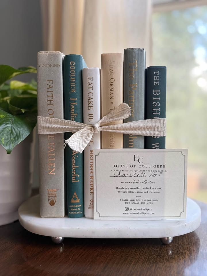 Curated collection of white, pale blue, sand, and soft coastal-neutral books with an airy, sun-faded look.