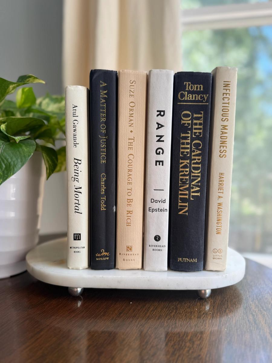 Curated collection of parchment, cream, warm beige, and black books with soft neutral contrast and classic detailing.