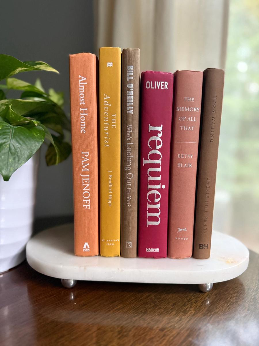 Curated collection of dusty rose, plum, warm brown, taupe, and muted berry-toned books with soft vintage character.