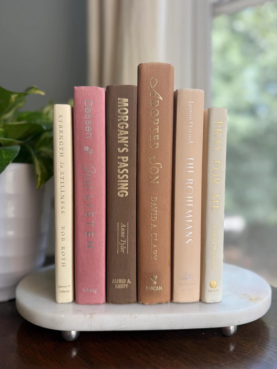 Curated collection of blush, dusty rose, warm taupe, and softly muted neutral books.