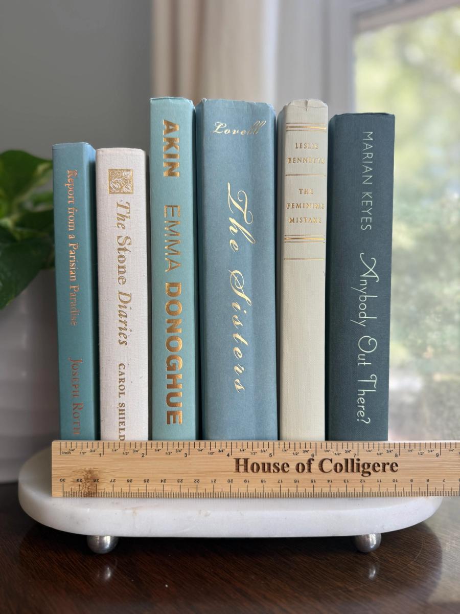 Curated collection of white, pale blue, sand, and soft coastal-neutral books with an airy, sun-faded look.